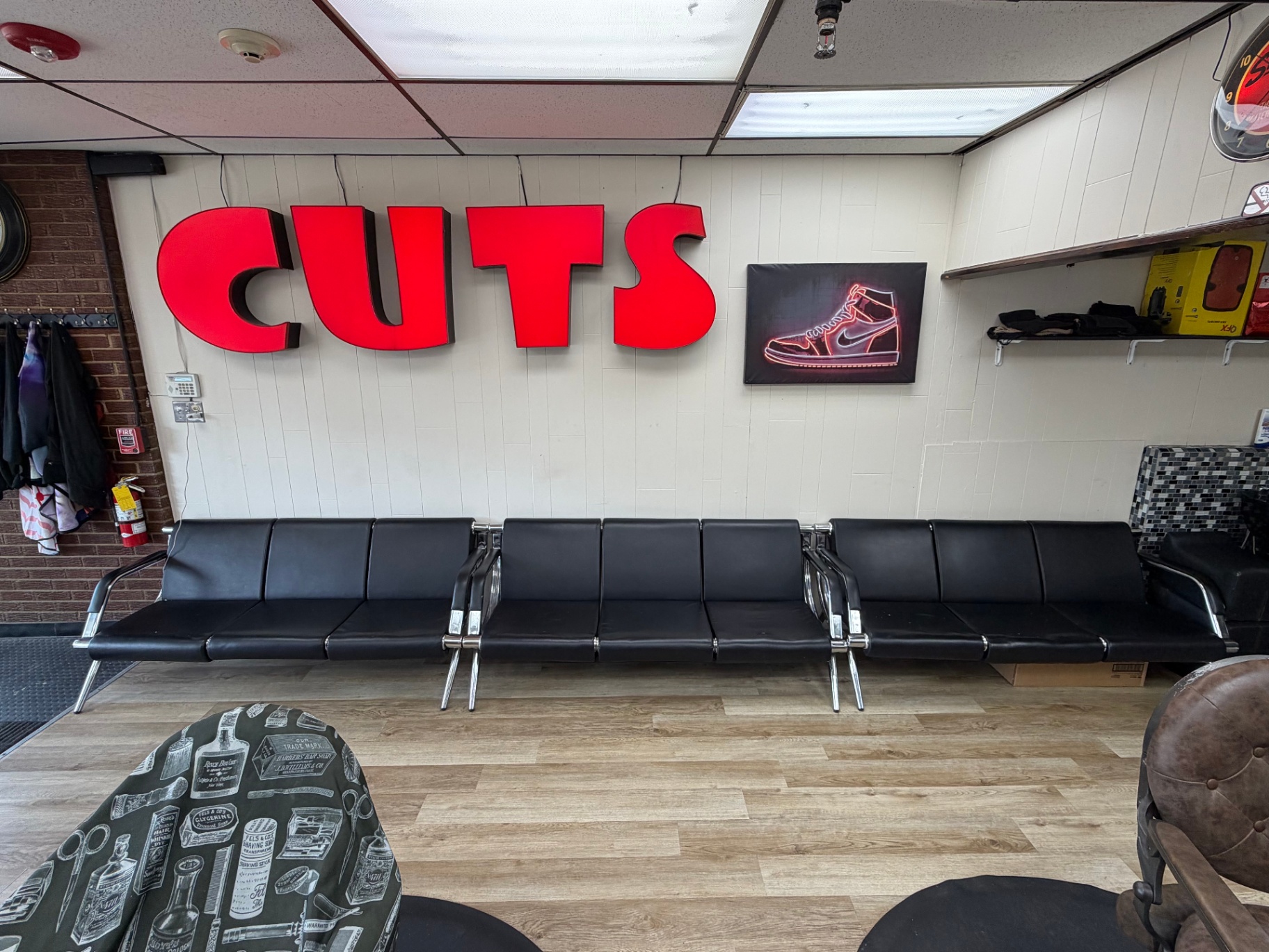 Big red CUTS sign over the waiting bench